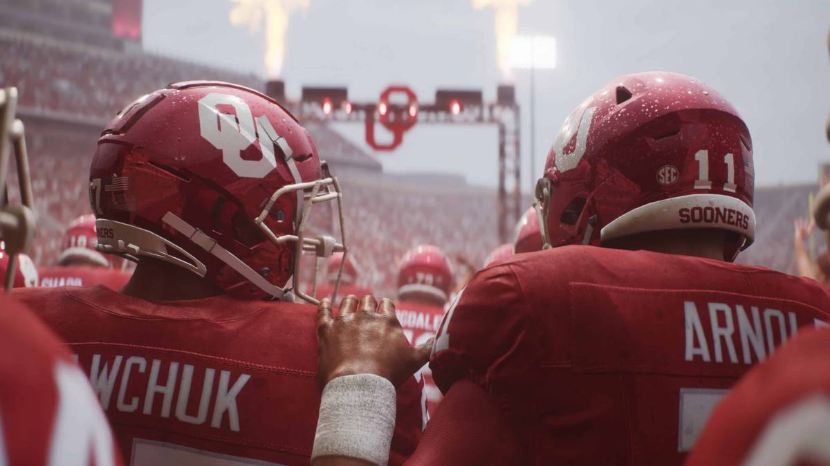 Two college football players, one has his hand on the other's shoulder