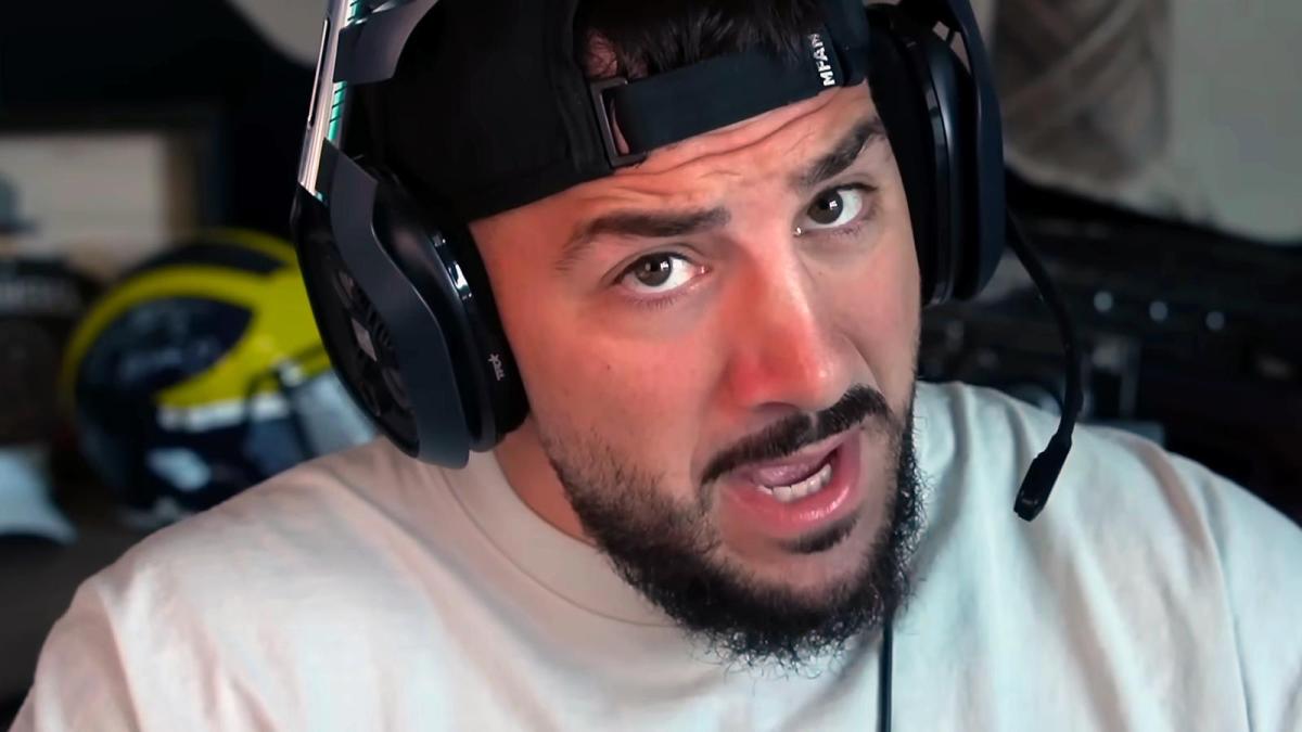 Kick content creator NICKMERCS speaks to the camera while wearing a large black headset and a white t-shirt.